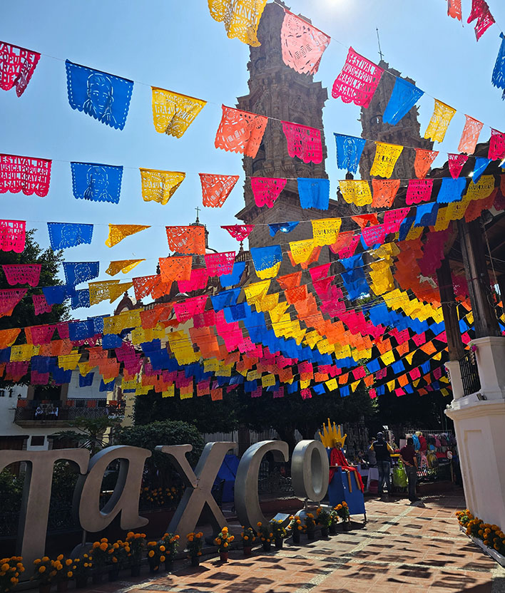 La preciosa plaza borda con su papel picado, el quiosco y las letras de Taxco además de todos los bonitos edificios que la rodean es una de las mejores cosas que ver en Taxco