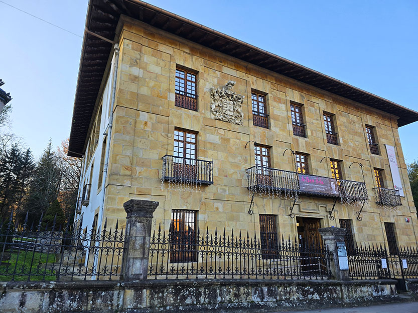 Edificio de piedra con balcones adornados con luces - Qué ver en Gernika