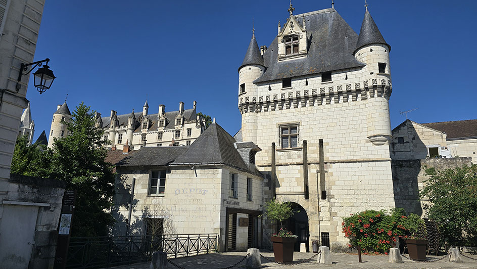 Puerta medieval de acceso al centro histórico con una casa a la izquierda y un edificio renacentista en lo alto - Qué ver en Loches