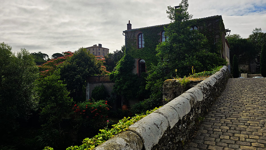 Vistas de una casa llena de enredaderas desde la Rue y Pont Saint-Antoine en el pueblo de Clisson